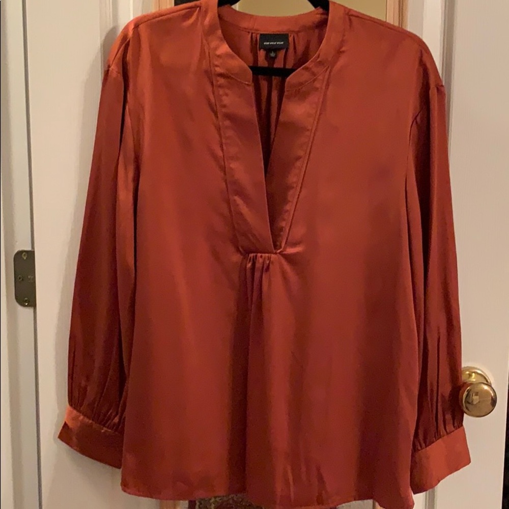 Long sleeve faux silk v-neck blouse.